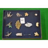 A collection of brooches.