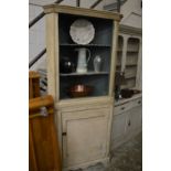 A painted standing corner cupboard.