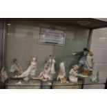 A large Nao group of a fisherman and a young girl together with Lladro and similar items.