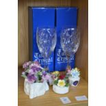 A pair of cut glass wine glasses and decorative china.