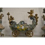 A decorative centrepiece modelled as a carriage with cherubs.