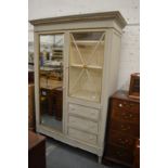 A good grey painted French armoire with a single mirrored door, glazed door and three small