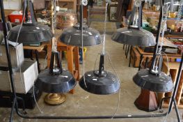 A set of six large black painted steel hanging lanterns.