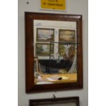 A walnut cushion framed mirror.