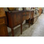 A mahogany serpentine fronted sideboard.