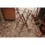 A wrought iron garden hose frame.