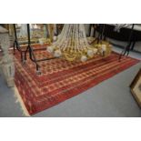 A good large Persian Bokhara carpet, beige ground with five rows of twenty two gulls 9' 10" x 7'