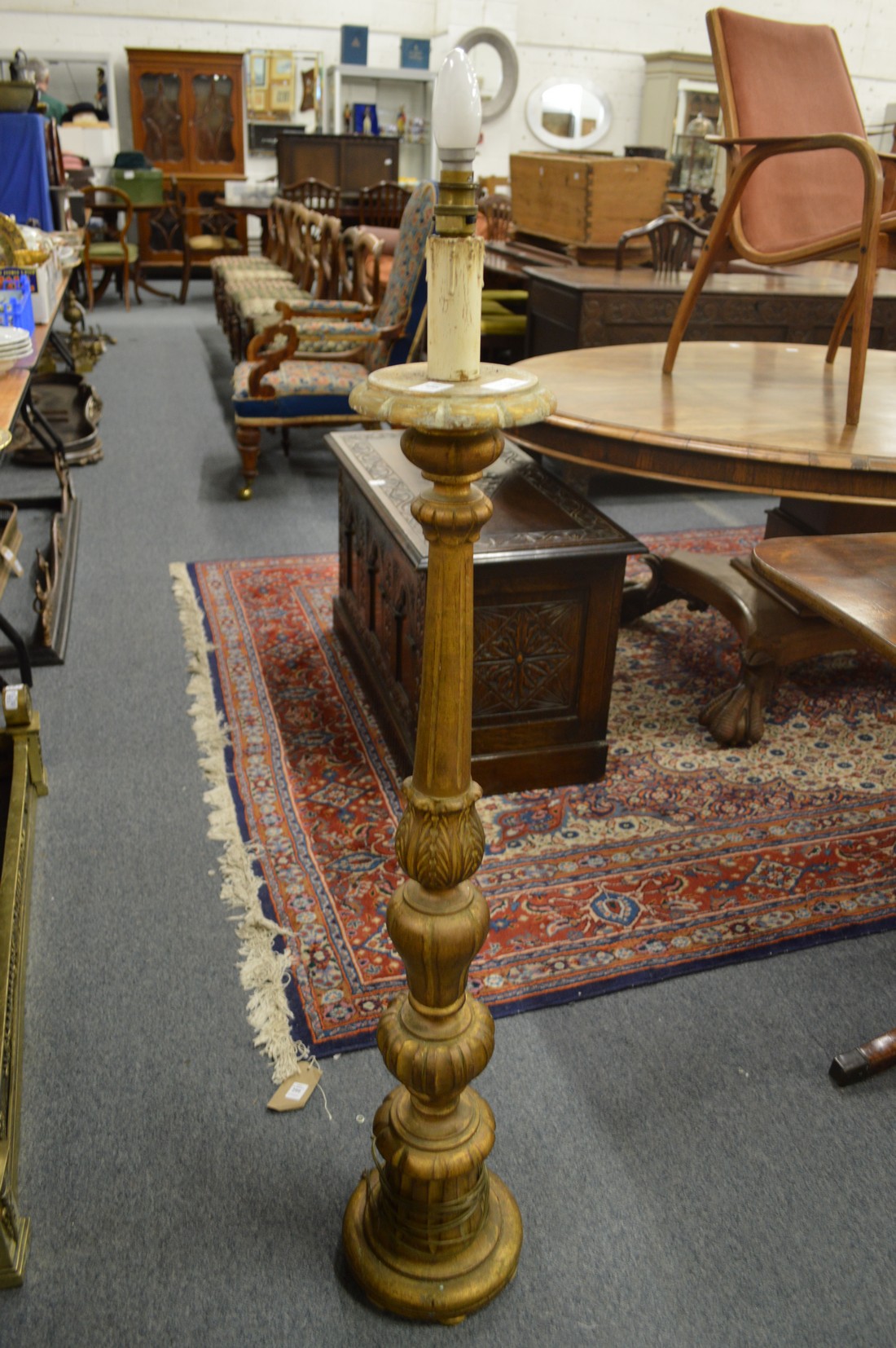 A carved giltwood floor standing lamp.