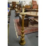A carved giltwood floor standing lamp.