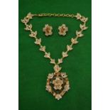A highly ornate necklace with pair of matching ear clips.
