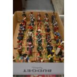 A large collection of miniature military figures on wooden bases.