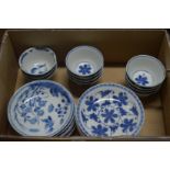 A collection of Chinese blue and white tea bowls and saucers.
