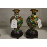 A small pair of cloisonne vases and stands.