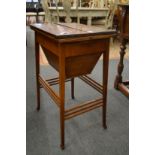 An Edwardian mahogany work table with bi-fold top.