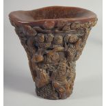 A GOOD CHINESE CARVED HORN LIBATION CUP carved with figures. 5.5ins long.