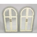 A PAIR OF GREY AND WHITE PAINTED ARCH SHAPED SHUTTER STYLE MIRRORS. 3ft 4ins x 1ft 9ins.