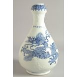 A CHINESE BLUE AND WHITE PORCELAIN GARLIC HEAD DRAGON VASE, the large dragon with carved relief