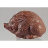 A CARVED WOOD NETSUKE, HOG.2.5ins Signed.