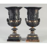 A PAIR OF RELIEF CAST CLASSICAL STYLE BRONZE CAMPAGNA URNS, on blue John style bases. 15ins high.