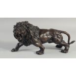 A BRONZE SNARLING LION. 12ins long.