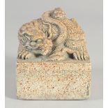 A CHINESE CARVED STONE SQUARE DRAGON SEAL. 3.75ins