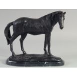 A BRONZE STANDING HORSE on a shaped marble base. 8ins high.