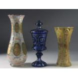 THREE VARIOUS BOHEMIAN GLASS VASES one with a cover. 13ins, 10ins & 9.5ins high.