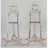 A PAIR OF SILVERED EASELS. 22ins long.