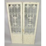 A PAIR OF WHITE PAINTED MIRRORS with metal grill decoration. 4ft 11ins x 1ft 5ins.