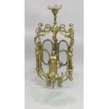 A LARGE GILT BRONZE HALL LANTERN with carytid figures and frosted glass panels (one panel off).