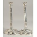 A PAIR OF GEORGE III CLUSTER COLUMN SILVER CANDLESTICK on loaded bases. 11ins high. London 1774.