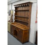 A good elm dresser with triple delft rack, six spice drawers, the base with three frieze drawers