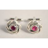 A PAIR OF SILVER RUBY KNOT CUFF LINKS.