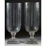 A GOOD PAIR OF ETCHED GLASS HURRICANE LAMPS on square bases.