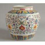 A CHINESE POLYCHROME "EIGHT TREASURE PATTERN" JAR, six character mark to the shoulder. 20.5cm high.