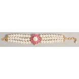 A PEARL BRACELET with GOLD PLATED RUBY CLASP.