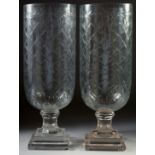 A GOOD PAIR OF ETCHED GLASS HURRICANE LAMPS on square bases.