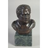 A SMALL BRONZE BUST OF A MAN on a marble base. 5ins high.