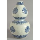 A CHINESE BLUE AND WHITE DOUBLE GOURD VASE decorated with flower heads and carved mice, with six