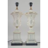 A PAIR OF GLASS URN SHAPED PEDESTAL TABLE LAMPS. 1ft 11ins high.
