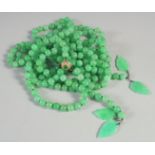 A DOUBLE ROW OF JADE BEADS with gold clasp. Approx 250 beads.