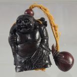 A THREE DIVISION HARDWOOD BUDDHA INRO. on a rope. 3.75ins long.