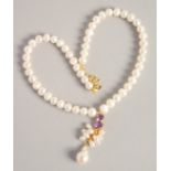 A PEARL NECKLACE with GOLD PLATED AMETHYST CLASP.