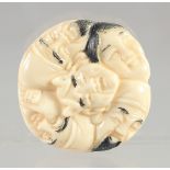 A CHINESE CARVED BONE FACES NETSUKE. 1.5ins