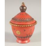 A TURKISH TOPHANE TERRACOTTA LIDDED POT, with gilt decoration, 14cm high.