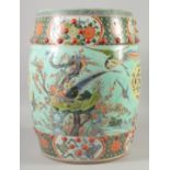 A CHINESE POLYCHROME PORCELAIN GARDEN SEAT, painted with exotic bird and flora, 45cm high.