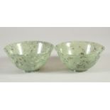 A PAIR OF CHINESE SPINACH JADE BOWLS, each 10cm diameter.