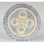 A PERSIAN -POSSIBLY SAFAVID, BLUE AND WHITE POTTERY DISH, 23cm diameter.