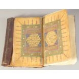 A 19TH CENTURY OTTOMAN LEATHER BOUND QURAN, 19cm x 12cm.