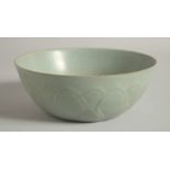 A CHINESE CELADON BOWL, with relief petal decoration to the exterior and moulded deer to the